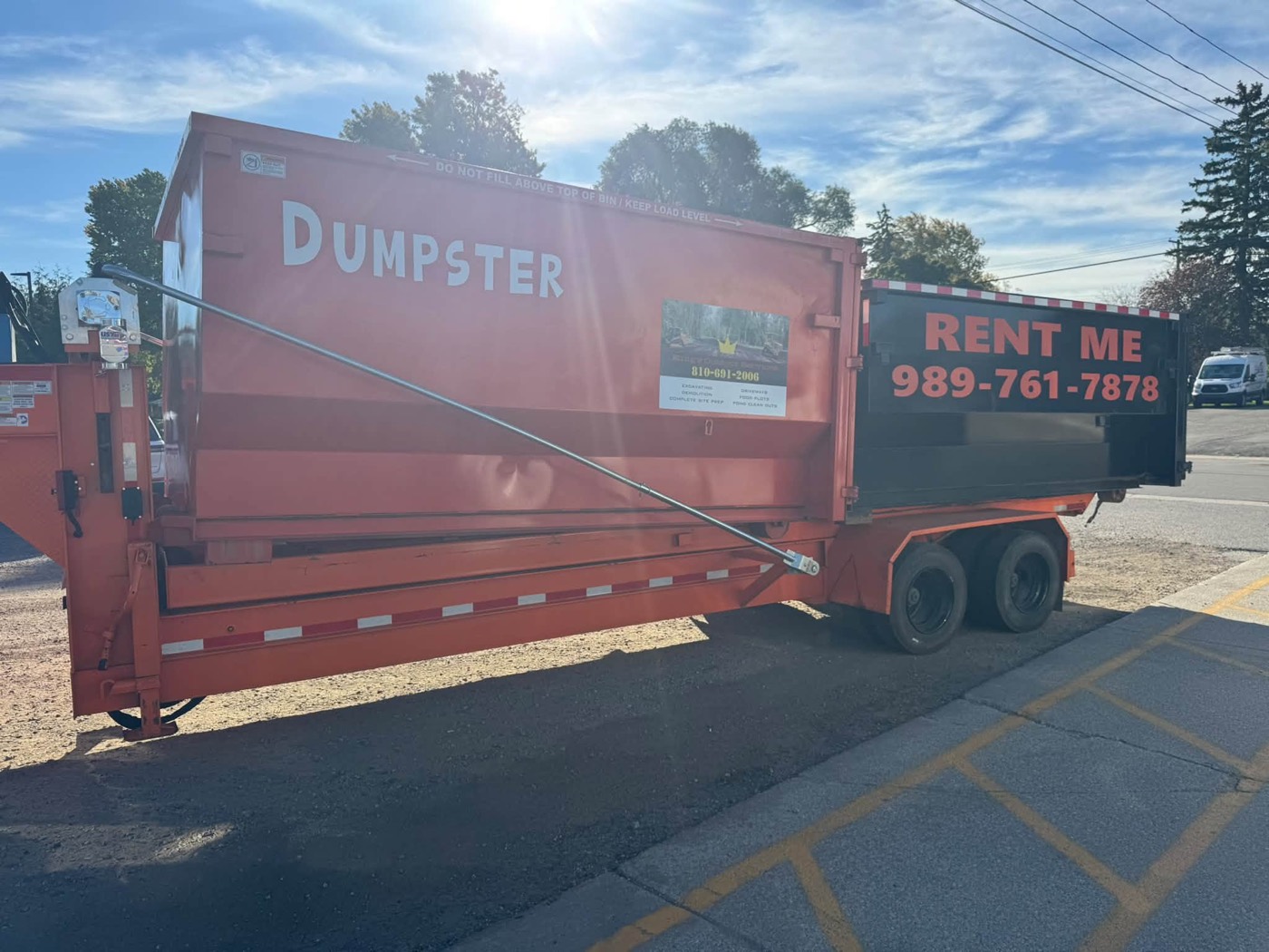 Orange roll-off dumpster delivered and ready to load